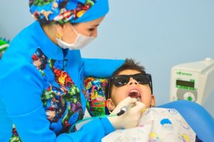 dentist fixing child's teeth
