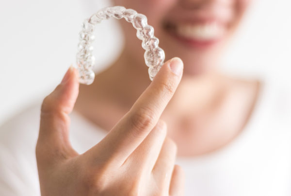 invisalign treatment explained to patient with retainer