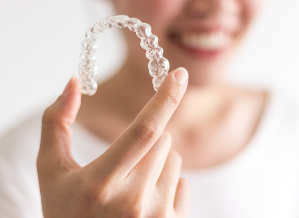 invisalign treatment explained to patient with retainer