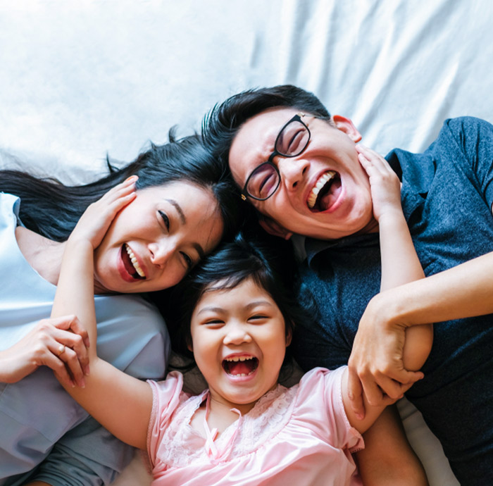Happy family smiling together while relaxing at home