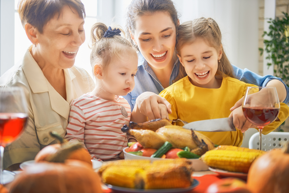 Happy multi-generational family enjoying a home-cooked meal together at the dining table